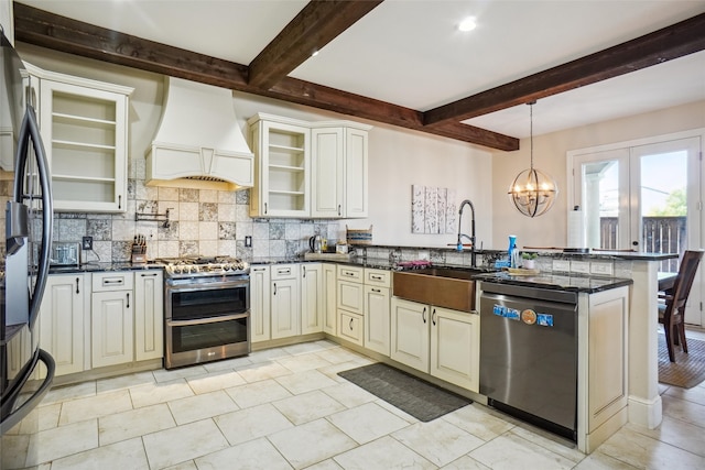 kitchen featuring a chandelier, stainless steel appliances, kitchen peninsula, premium range hood, and beam ceiling