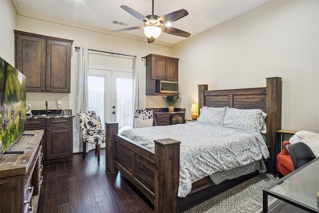 bedroom featuring dark wood-type flooring, french doors, and ceiling fan