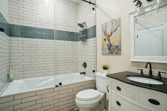 full bathroom with tiled shower / bath, toilet, and vanity