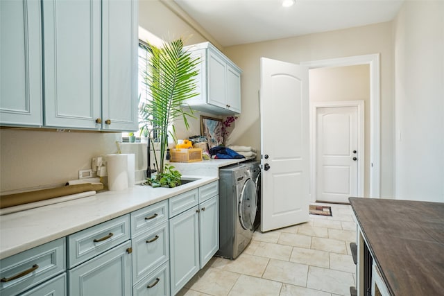 kitchen with washing machine and clothes dryer, butcher block countertops, and light tile patterned flooring