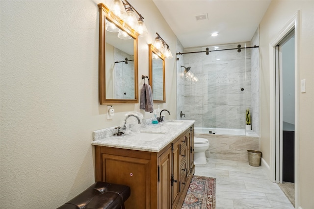 full bathroom with vanity, toilet, and tiled shower / bath combo