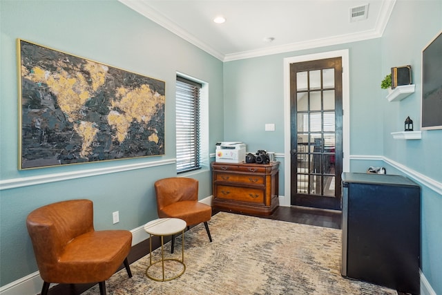 living area featuring ornamental molding and wood-type flooring