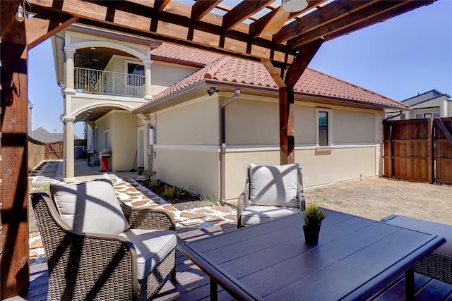 exterior space with a balcony and a pergola