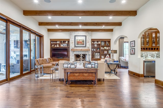 living room featuring a fireplace, dark hardwood / wood-style flooring, and beam ceiling