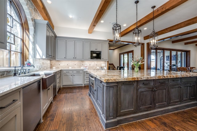 kitchen featuring gray cabinetry, dishwasher, a center island, an inviting chandelier, and pendant lighting