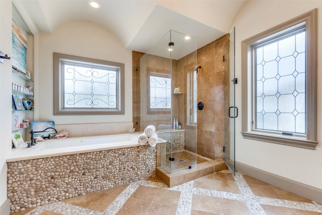 bathroom with vaulted ceiling and independent shower and bath