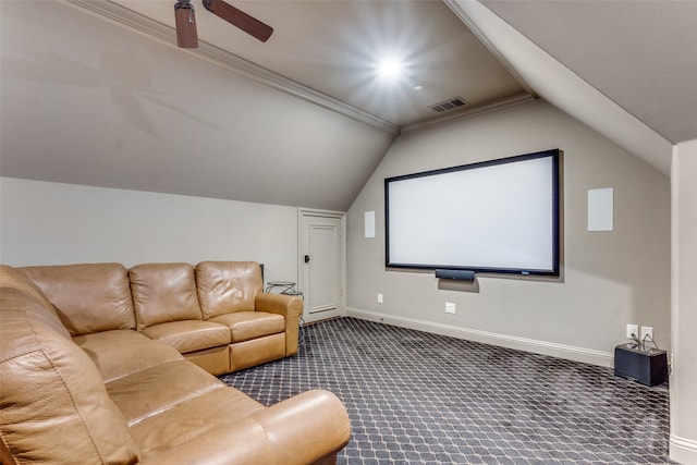 cinema room featuring crown molding, lofted ceiling, dark colored carpet, and ceiling fan