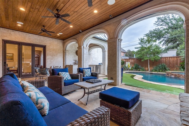 view of patio with a fenced in pool, an outdoor hangout area, and ceiling fan