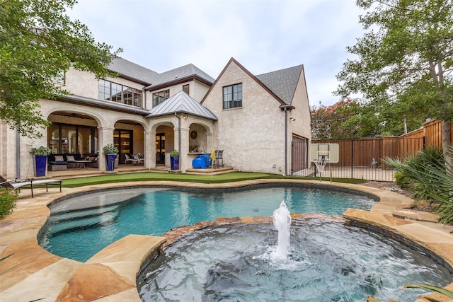 view of pool with a patio area and an in ground hot tub