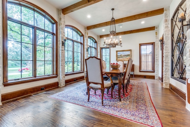 dining space with an inviting chandelier, a wealth of natural light, and wood-type flooring