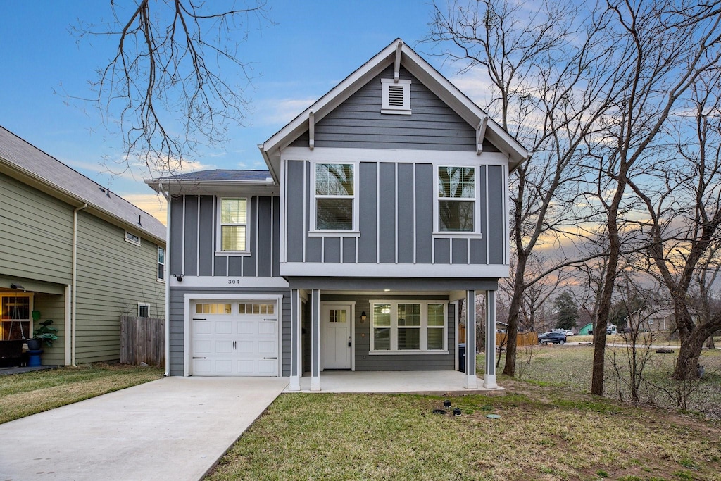 view of front of house with a garage and a yard