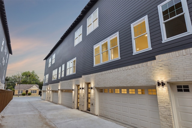 property exterior at dusk with a garage