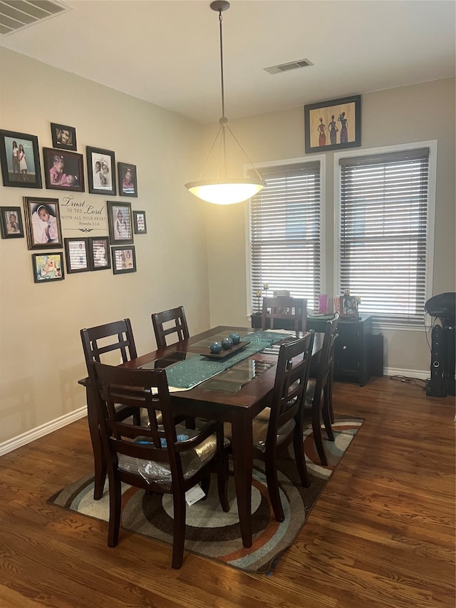 dining area with dark wood-type flooring