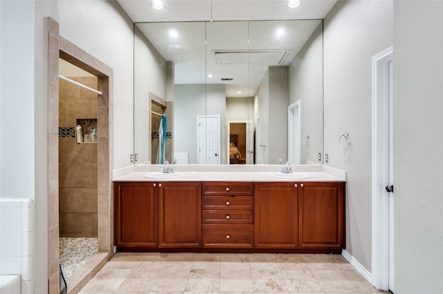 bathroom with vanity and tiled shower