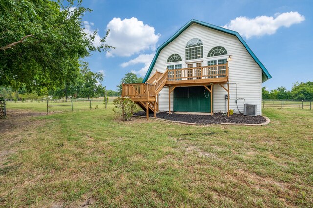 exterior space featuring central AC, a lawn, and a rural view