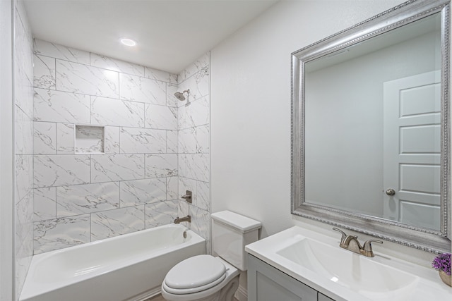 full bathroom with tiled shower / bath combo, vanity, and toilet