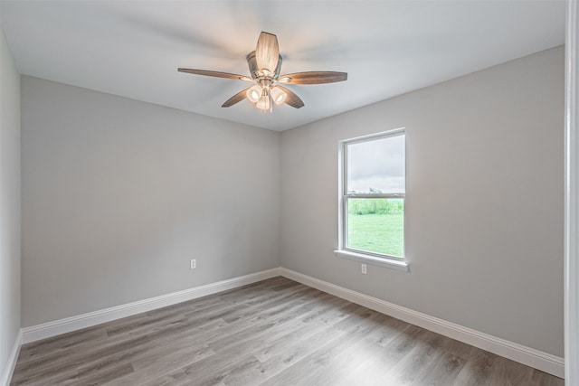 spare room with hardwood / wood-style floors and ceiling fan