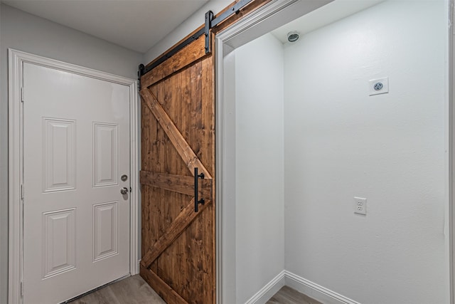 interior space featuring a barn door and hardwood / wood-style floors