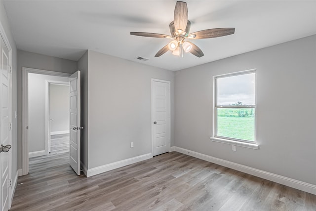 unfurnished bedroom featuring wood-type flooring and ceiling fan