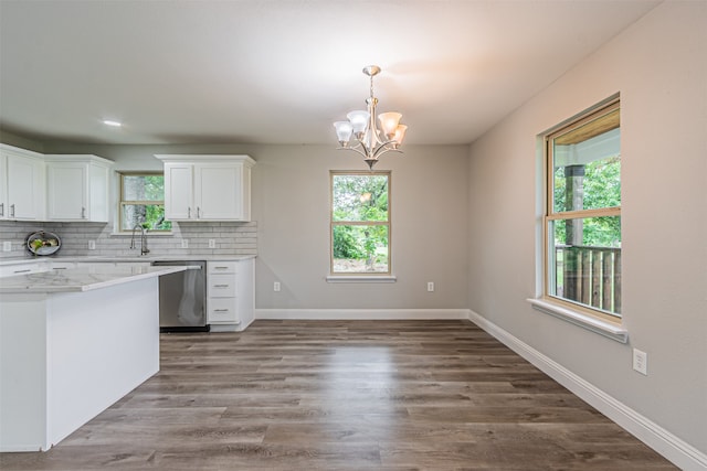 kitchen featuring white cabinets, wood-type flooring, light stone counters, and stainless steel dishwasher