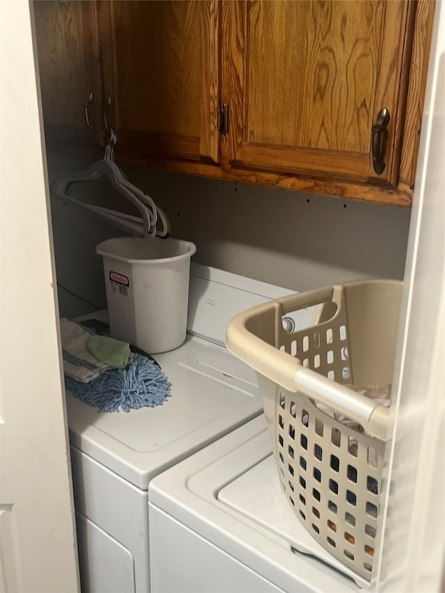 washroom with cabinets and separate washer and dryer