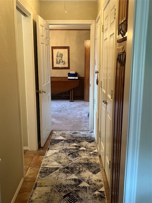 hallway with light colored carpet