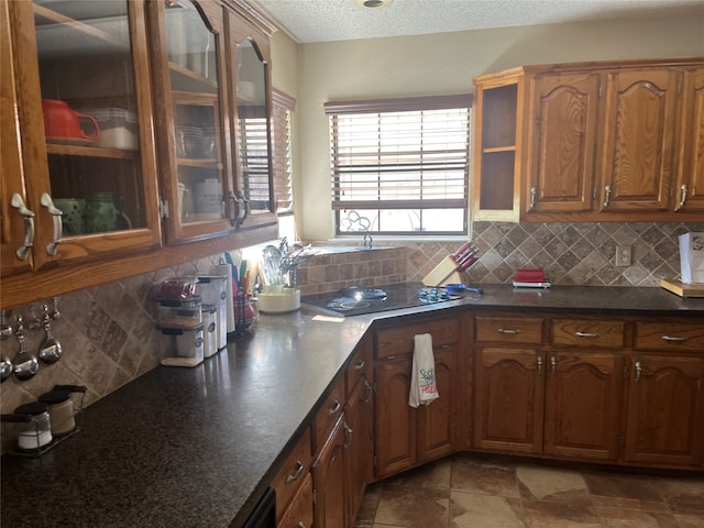 kitchen featuring a textured ceiling and backsplash