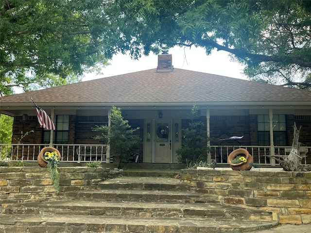 rear view of property with a porch