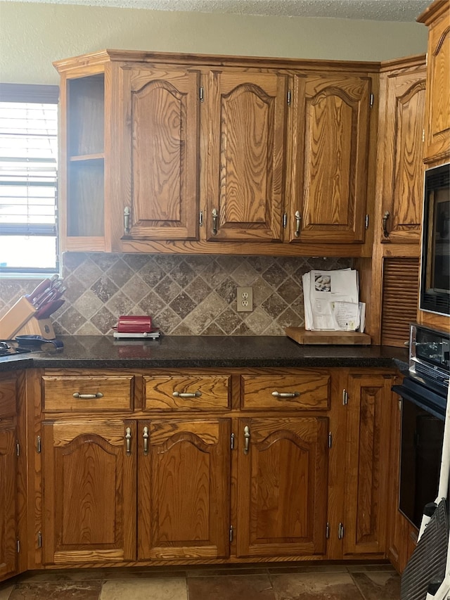 kitchen featuring tasteful backsplash and black appliances