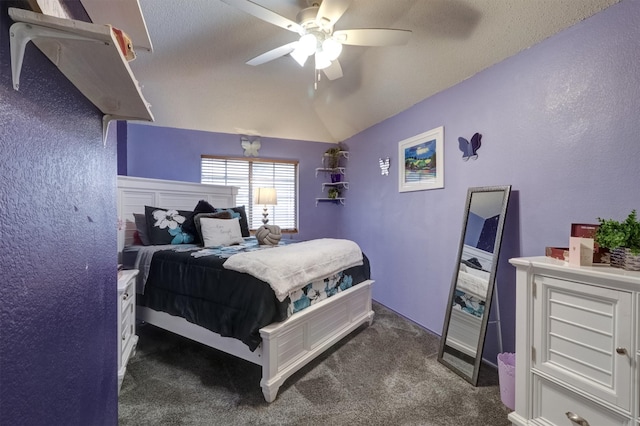 bedroom featuring dark carpet, ceiling fan, a textured ceiling, and vaulted ceiling