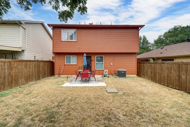 back of property featuring a patio area, a lawn, and central air condition unit