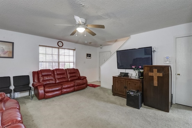 living room with light carpet, a textured ceiling, and ceiling fan