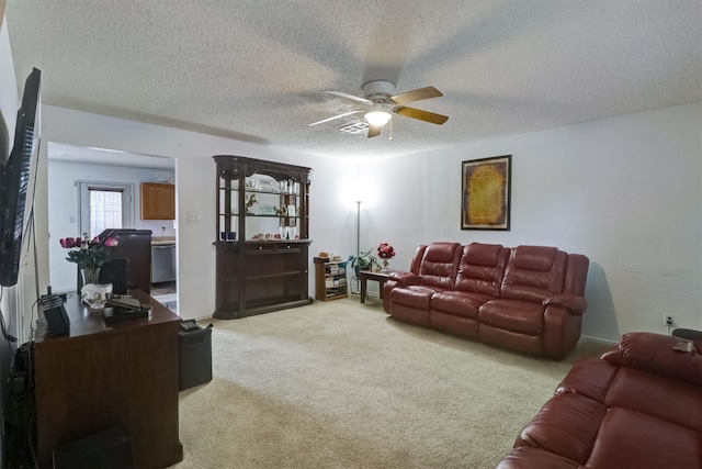 carpeted living room featuring a textured ceiling and ceiling fan