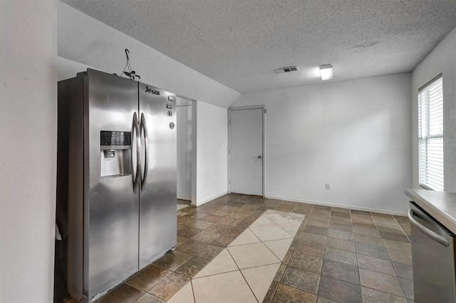 kitchen featuring a textured ceiling and stainless steel appliances