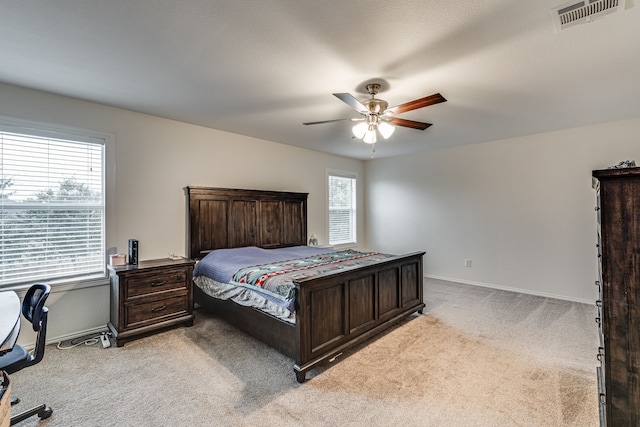 bedroom featuring light carpet and ceiling fan