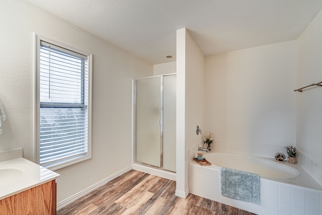 bathroom featuring hardwood / wood-style floors, vanity, a textured ceiling, and separate shower and tub