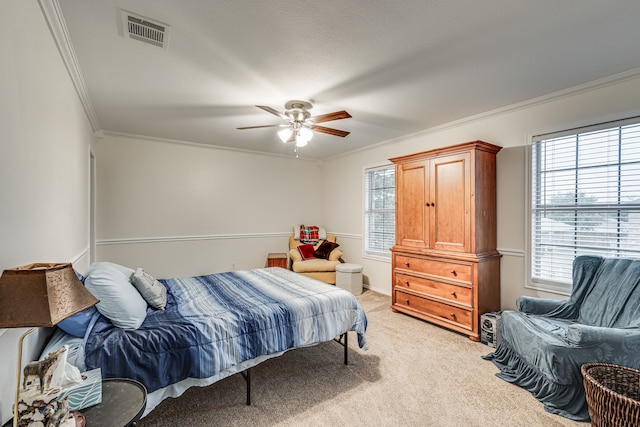 carpeted bedroom featuring ornamental molding, a textured ceiling, and ceiling fan