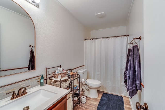 bathroom with tasteful backsplash, vanity, hardwood / wood-style flooring, and ornamental molding