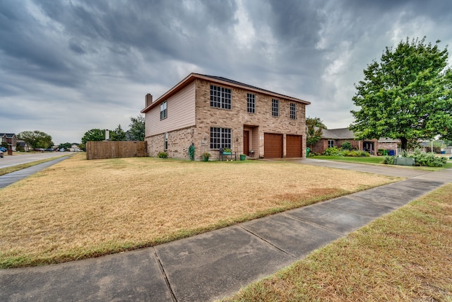 view of front of home featuring a garage and a front yard