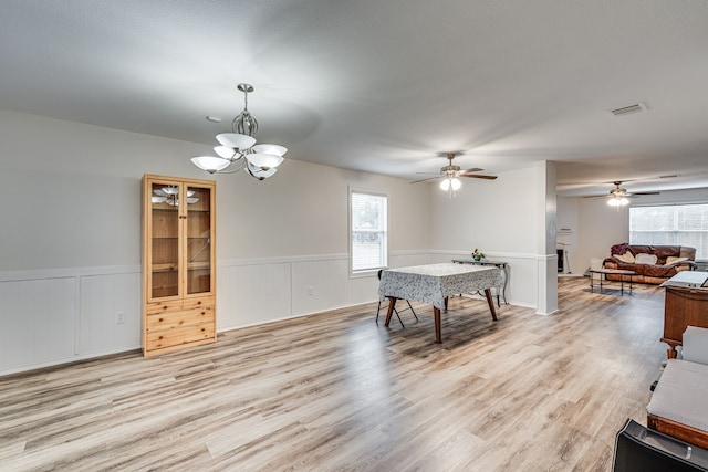 dining area with an inviting chandelier and light hardwood / wood-style flooring