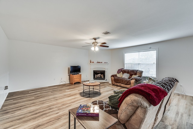 living room featuring hardwood / wood-style flooring and ceiling fan