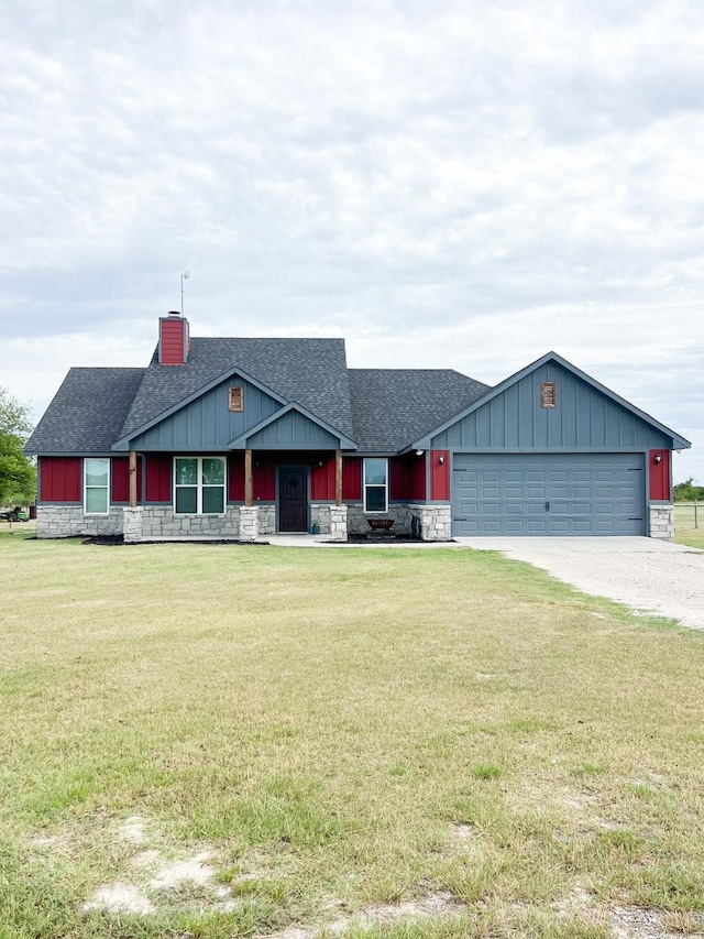 view of front of property featuring a garage and a front lawn