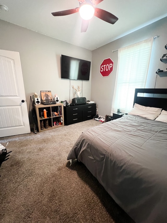 bedroom with ceiling fan and carpet floors