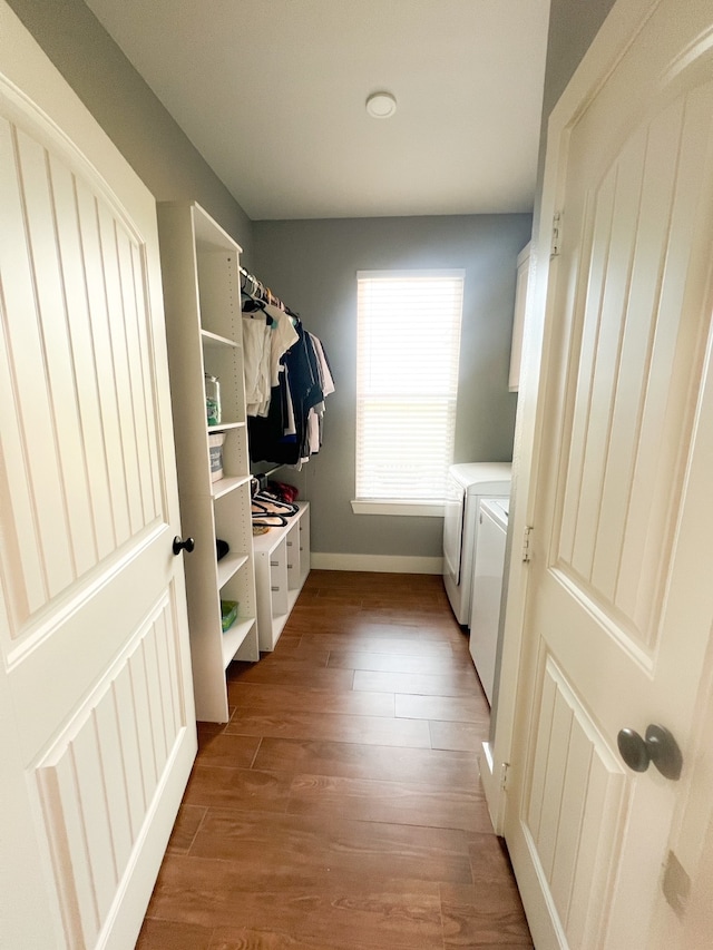 washroom featuring wood-type flooring and independent washer and dryer