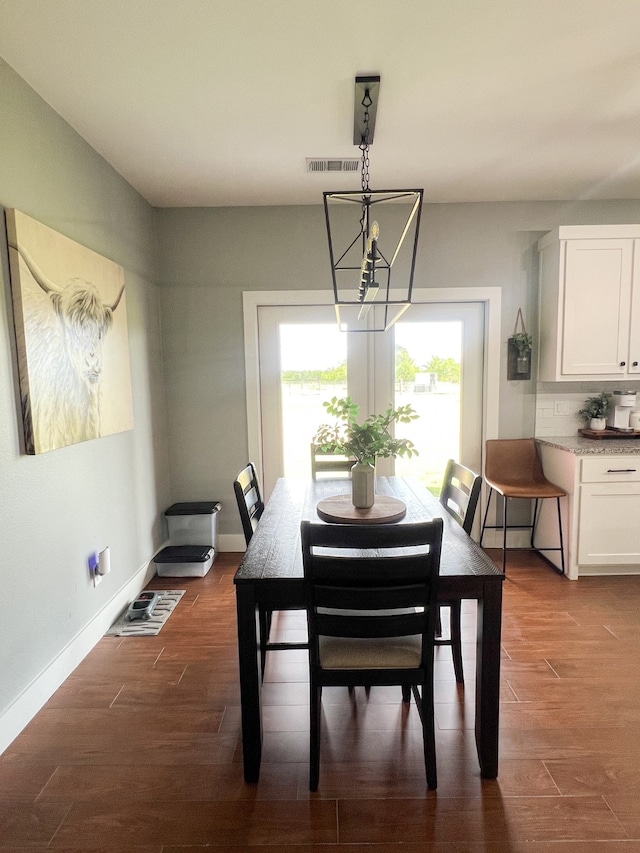 dining room featuring a chandelier and dark hardwood / wood-style flooring