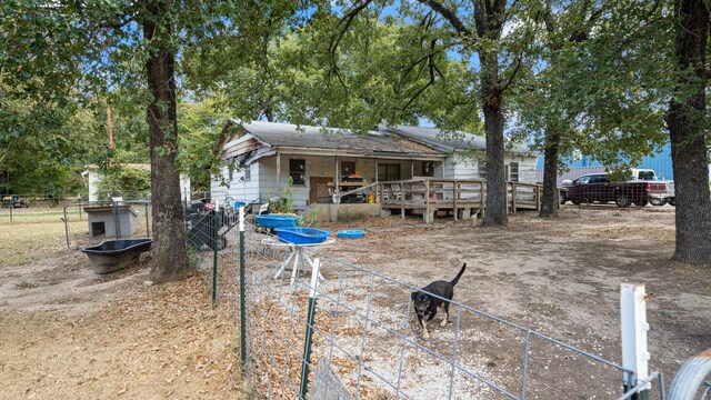 rear view of house featuring a deck