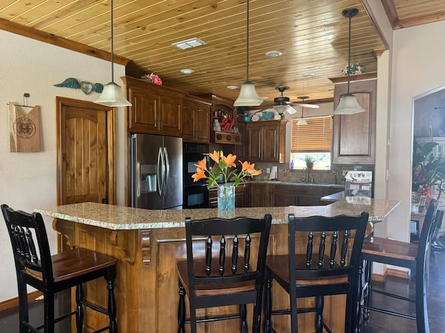 kitchen featuring pendant lighting, wooden ceiling, light stone countertops, ceiling fan, and stainless steel refrigerator with ice dispenser