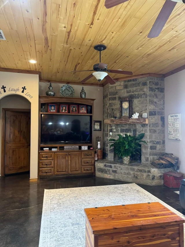 living room with ceiling fan, wood ceiling, a fireplace, and ornamental molding