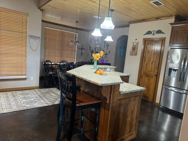 kitchen with decorative light fixtures, light stone counters, a kitchen island, stainless steel fridge with ice dispenser, and wood ceiling