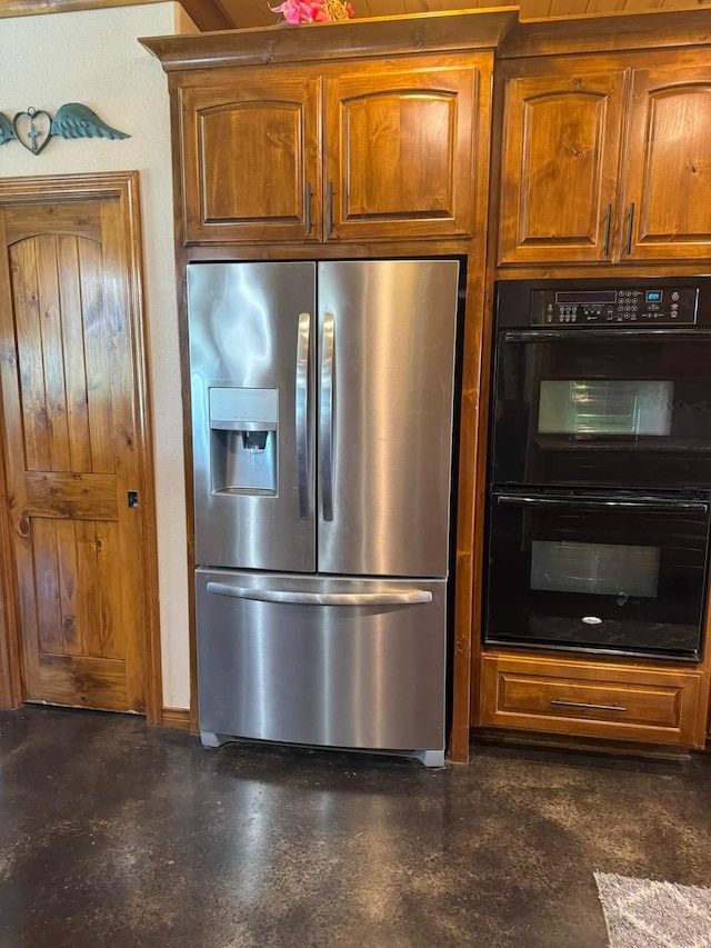 kitchen with black double oven and stainless steel fridge with ice dispenser